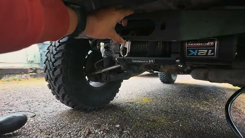 Rear winch, mounting brackets, and fairlead positioned beneath the Grand Cherokee's hitch area