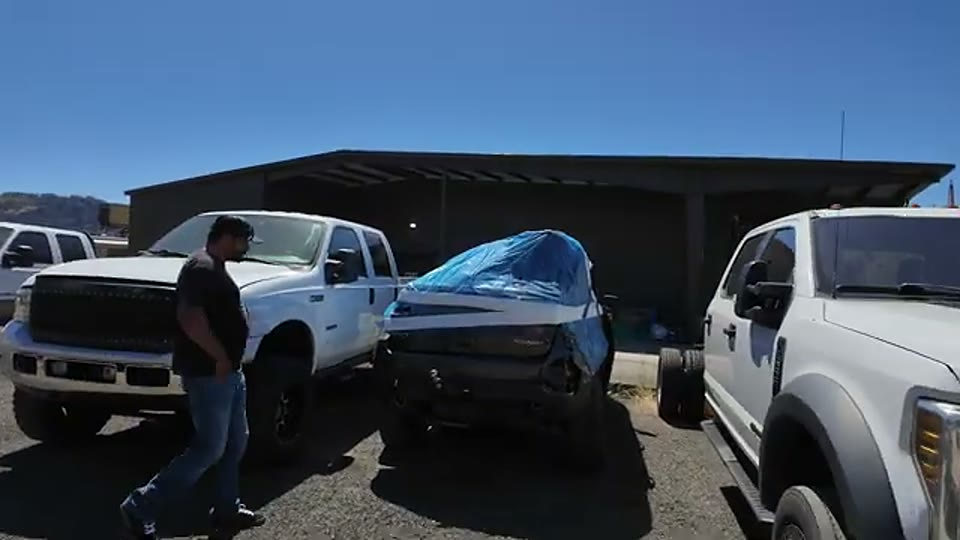 The wrecked Trailhawk donor in the yard before its drivetrain parts were recovered