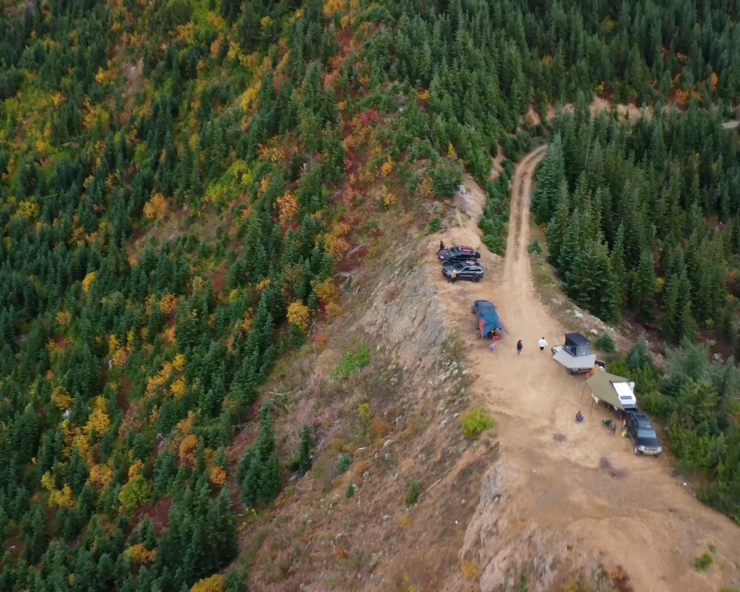 Vehicles beside a forested ridge, from the published Roaring Ridge event page.